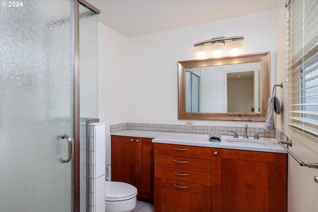 full bath featuring tile patterned floors, toilet, a stall shower, and vanity