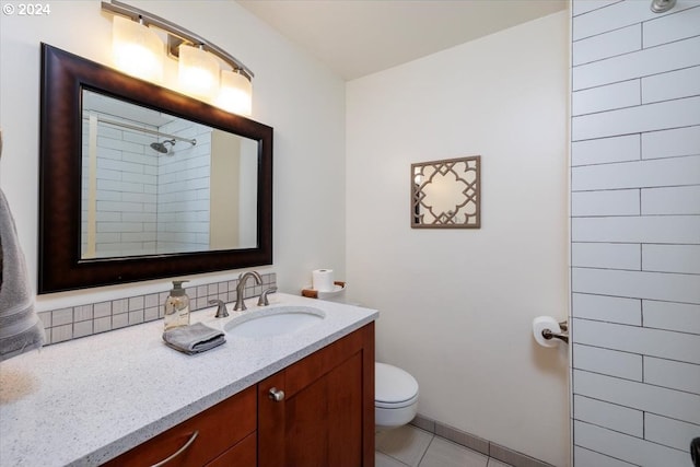 bathroom featuring tile patterned floors, toilet, a shower, and vanity