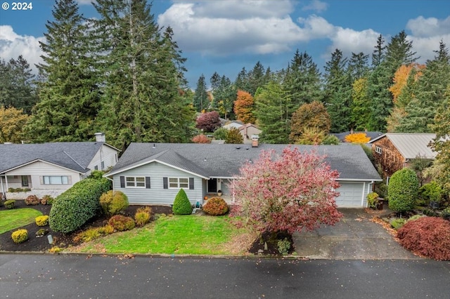 view of front of home with a garage and a front lawn