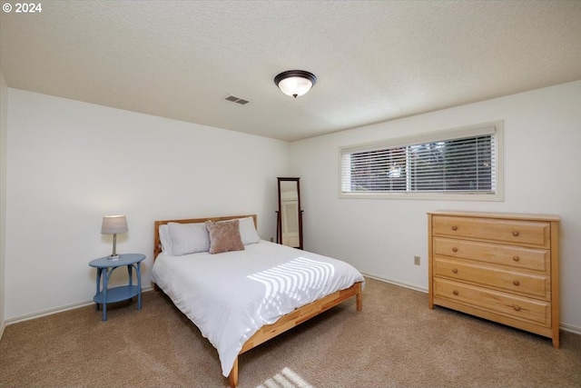 bedroom with baseboards, carpet, and visible vents