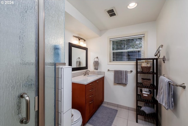 bathroom with a stall shower, vanity, tile patterned flooring, and visible vents