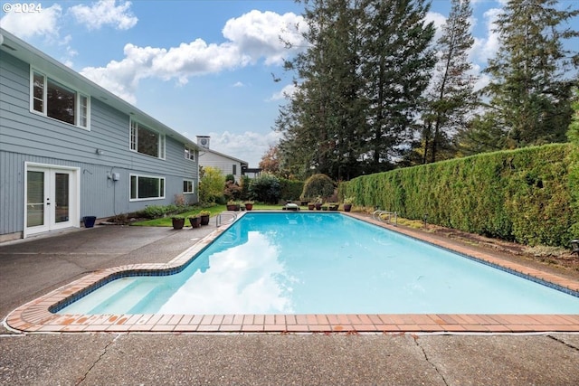 view of pool featuring a patio area, french doors, and a fenced in pool