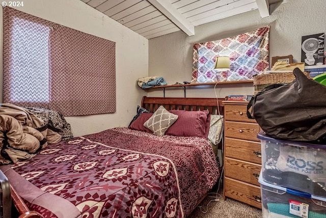 bedroom with carpet floors and lofted ceiling with beams