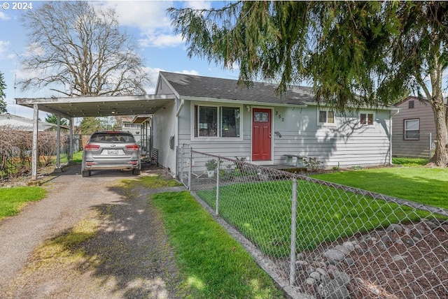 view of front of property with a carport and a front lawn