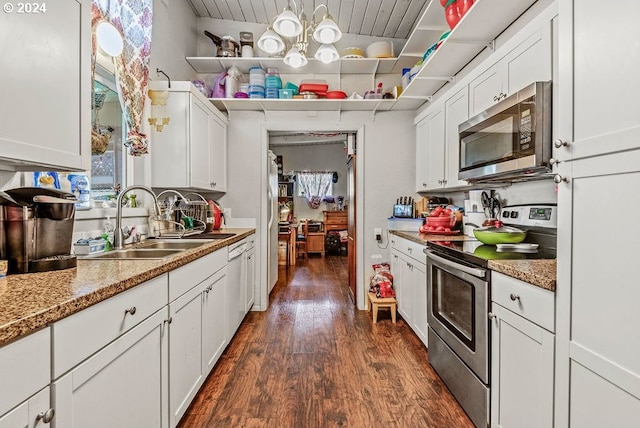 kitchen with dark wood-type flooring, sink, light stone countertops, appliances with stainless steel finishes, and white cabinetry