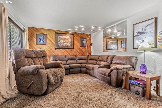 carpeted living room featuring wooden walls and a textured ceiling