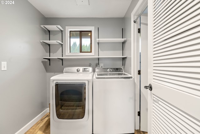 washroom featuring light wood-type flooring and separate washer and dryer