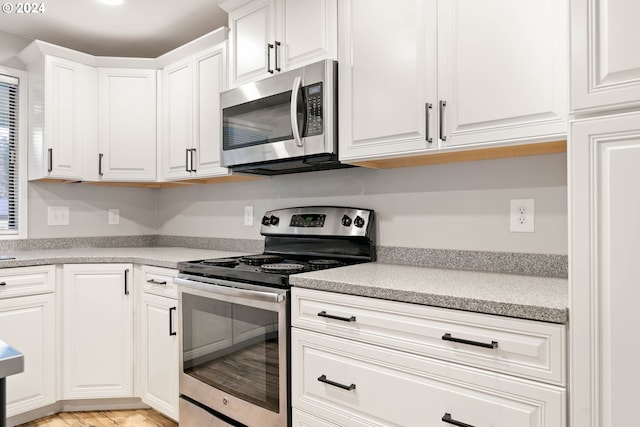 kitchen featuring white cabinetry and stainless steel appliances