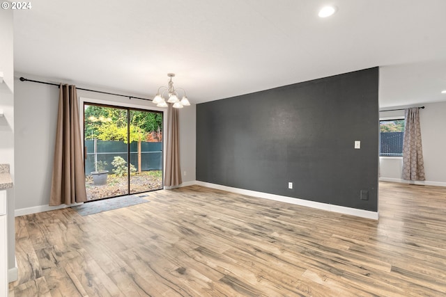 interior space with an inviting chandelier and light wood-type flooring