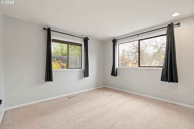 spare room with light colored carpet