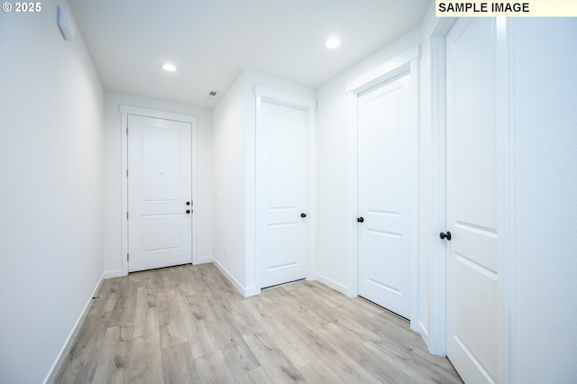 hall with light hardwood / wood-style flooring