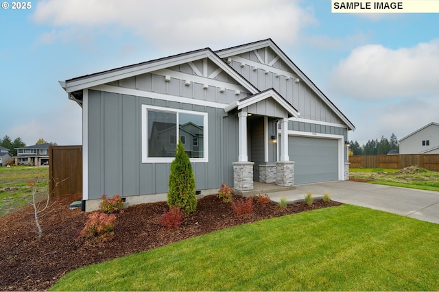 craftsman house featuring a front yard and a garage