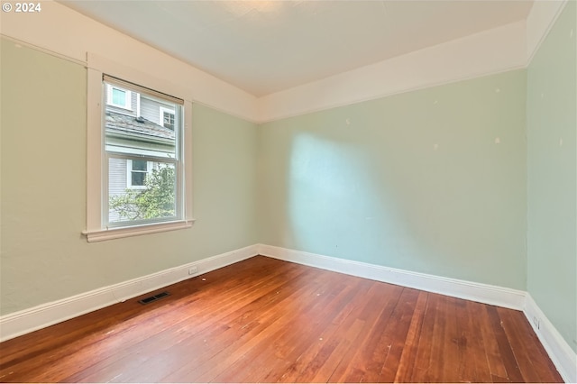 unfurnished room featuring hardwood / wood-style flooring