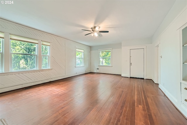 spare room with baseboard heating, ceiling fan, and hardwood / wood-style floors