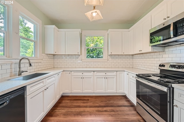 kitchen with sink, backsplash, white cabinets, dark hardwood / wood-style flooring, and stainless steel appliances