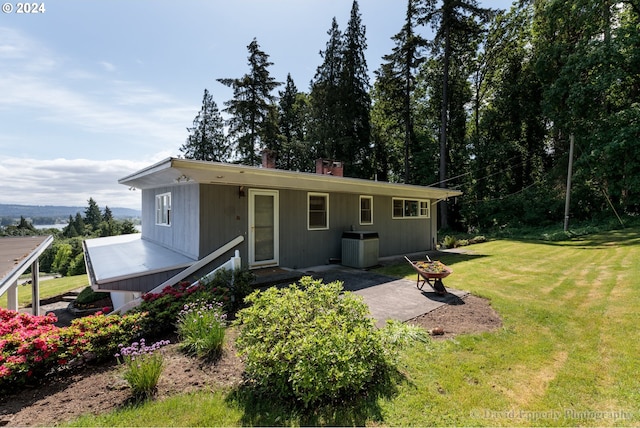 single story home with a front yard and a patio area