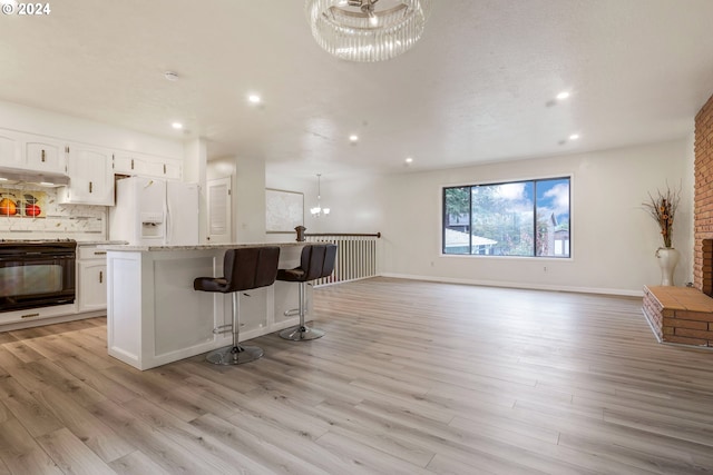 kitchen featuring light hardwood / wood-style floors, white cabinets, and white refrigerator with ice dispenser