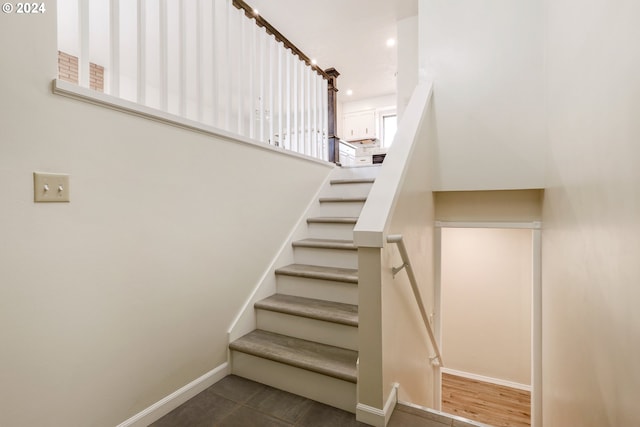 stairway featuring hardwood / wood-style floors