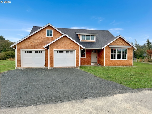 view of front of property featuring a garage and a front lawn