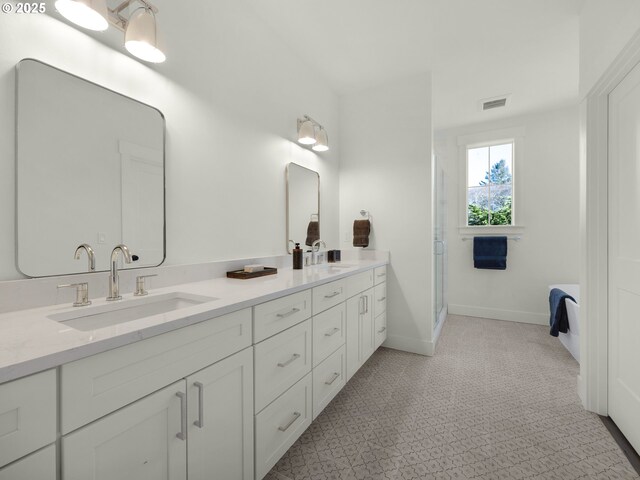 bathroom with a shower with door and vanity