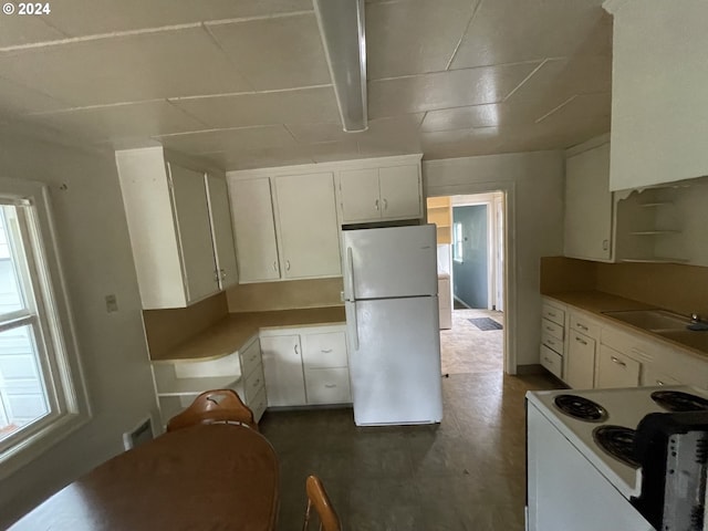 kitchen with white cabinetry, sink, and white appliances