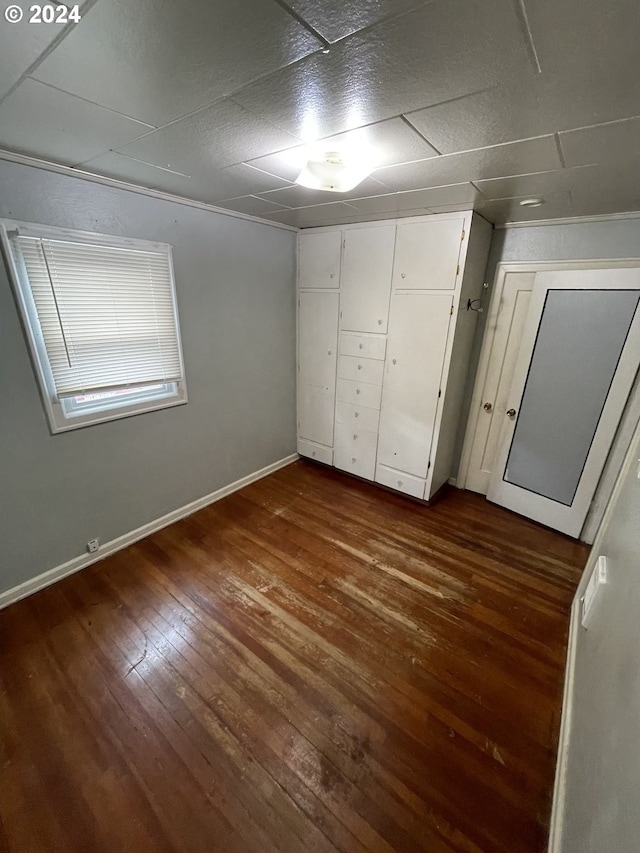 unfurnished bedroom with dark hardwood / wood-style floors