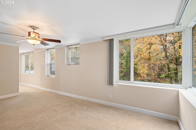 1205 SW Cardinell Dr Unit 802, Portland, OR 97201 - empty room featuring light carpet, a ceiling fan, healthy amount of natural light, and crown molding