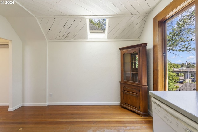 bonus room with vaulted ceiling with skylight, wood ceiling, and light hardwood / wood-style flooring