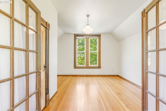 bonus room with lofted ceiling and light hardwood / wood-style flooring