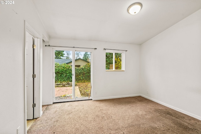 unfurnished room featuring light carpet