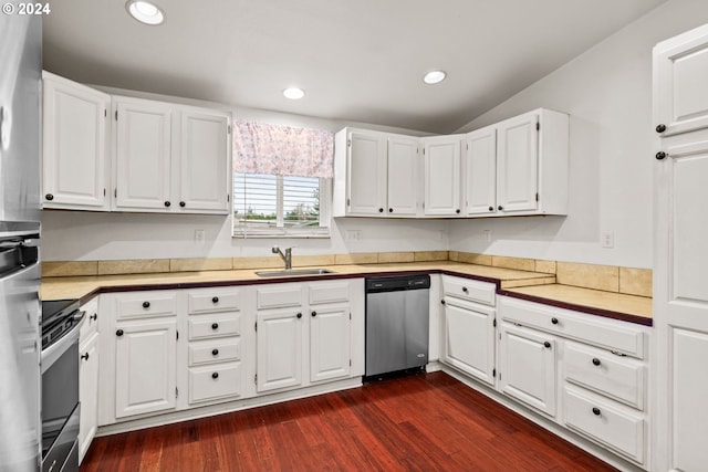 kitchen featuring lofted ceiling, dark wood-type flooring, sink, appliances with stainless steel finishes, and white cabinetry