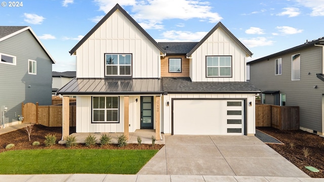 modern farmhouse style home with a front yard and a garage