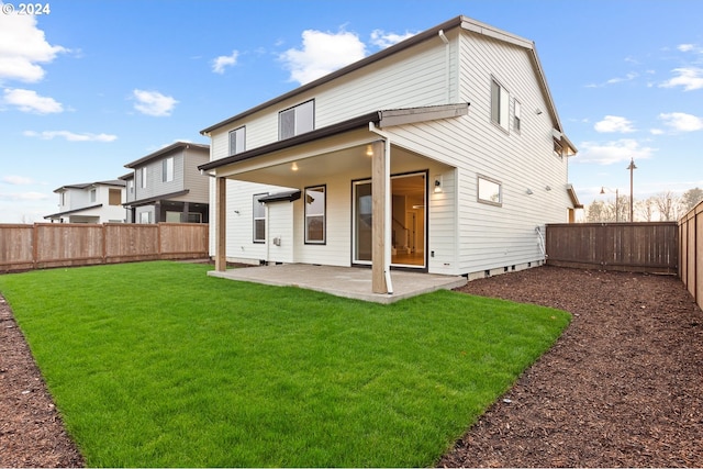 back of property featuring a lawn and a patio area