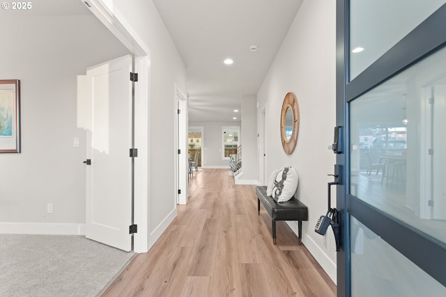 corridor with light hardwood / wood-style floors