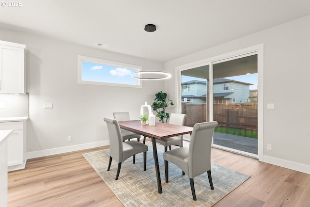 dining space with light hardwood / wood-style flooring