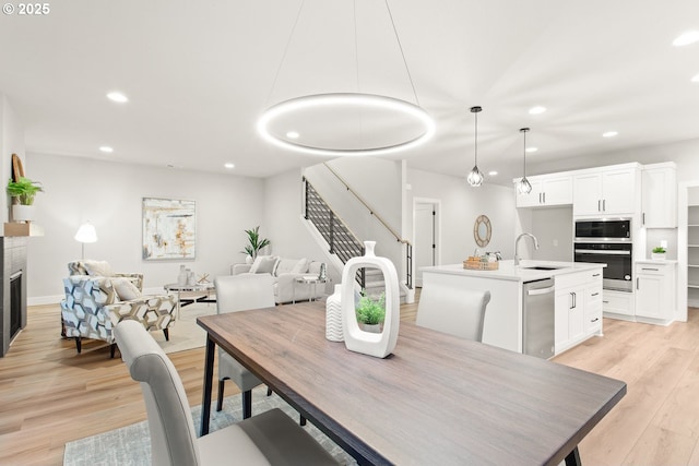 dining room with sink and light hardwood / wood-style floors