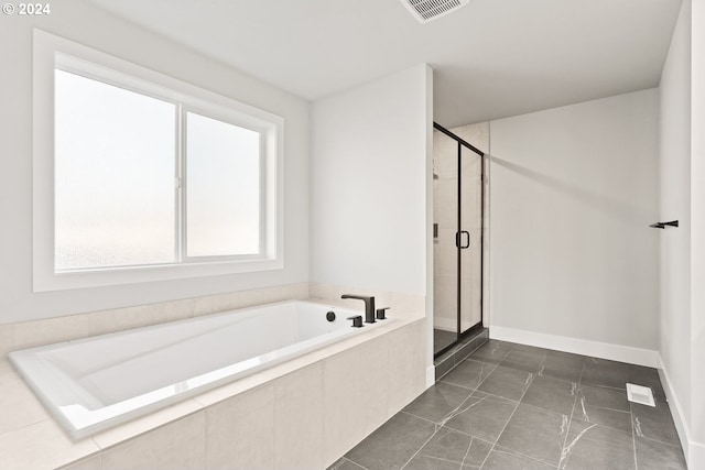 bathroom with tile patterned flooring and independent shower and bath