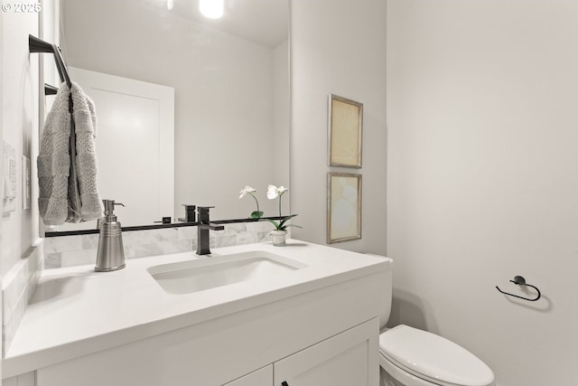 bathroom with toilet and vanity