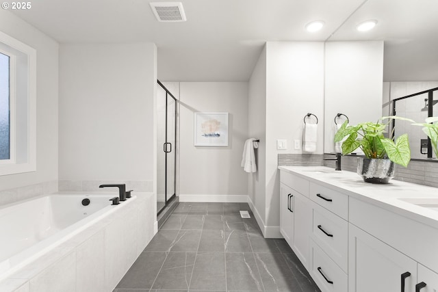 bathroom with vanity and separate shower and tub