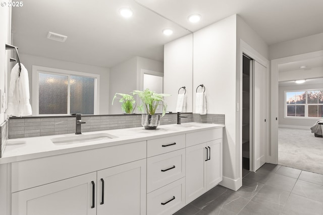 bathroom featuring decorative backsplash and vanity