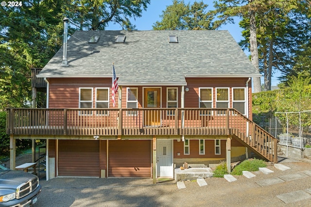 back of property featuring a deck