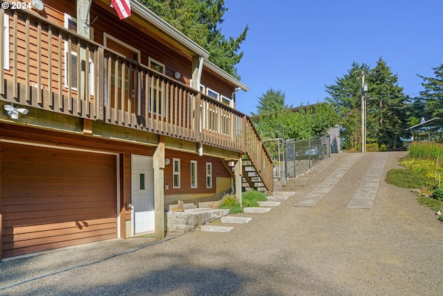 view of property exterior featuring a wooden deck