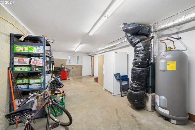 basement with electric water heater and white refrigerator