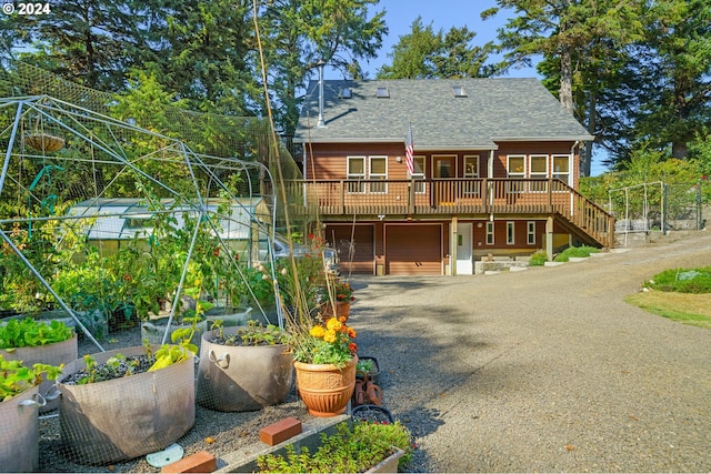 view of front of house with a garage and a deck