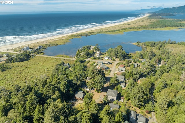 aerial view with a water view and a beach view