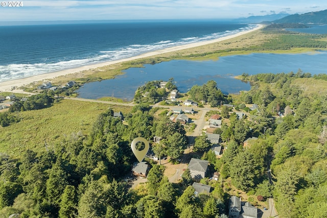 drone / aerial view with a water view and a beach view