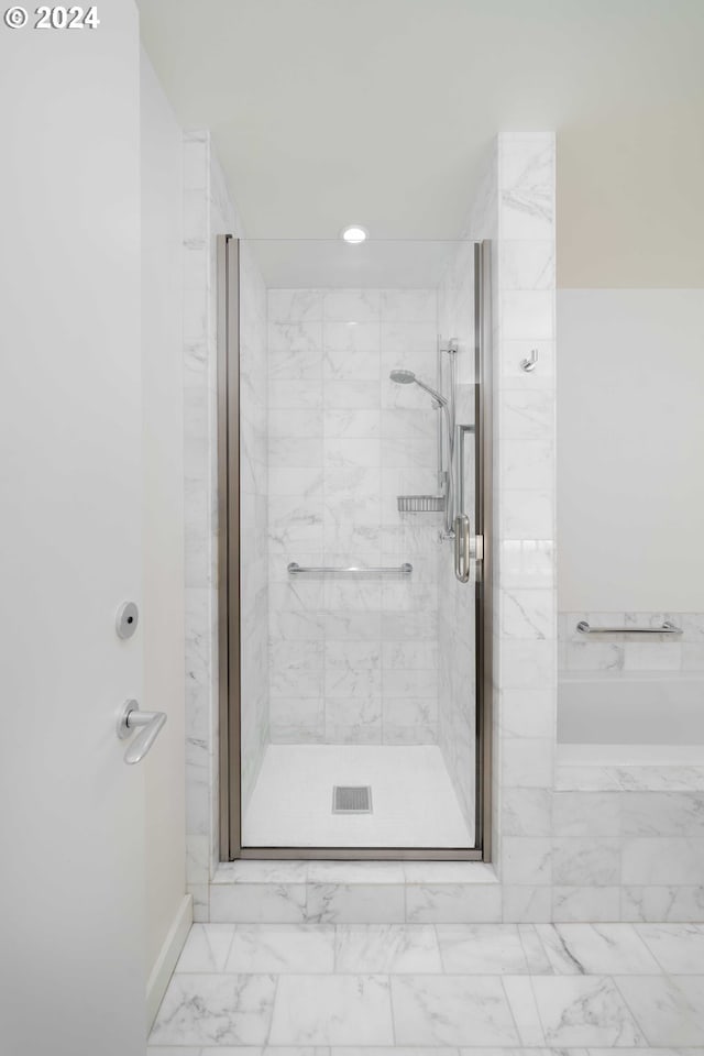 bathroom featuring a shower with door and tile patterned flooring