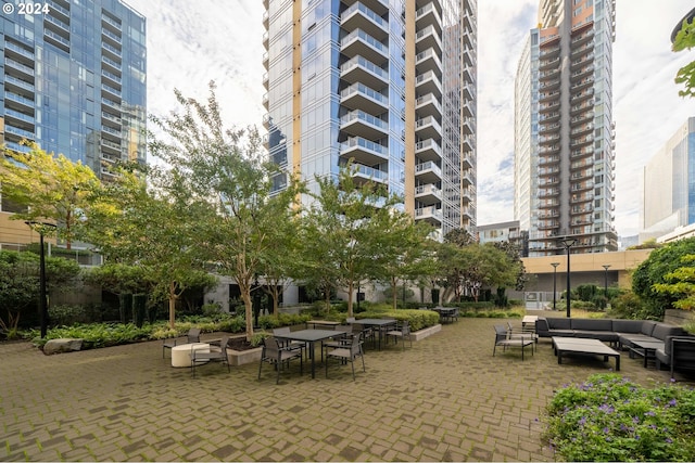 view of property's community with an outdoor hangout area and a patio