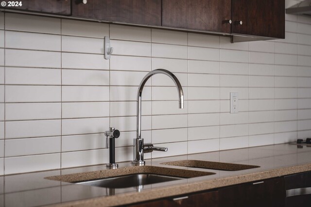 details featuring dark brown cabinets, backsplash, stone countertops, and sink