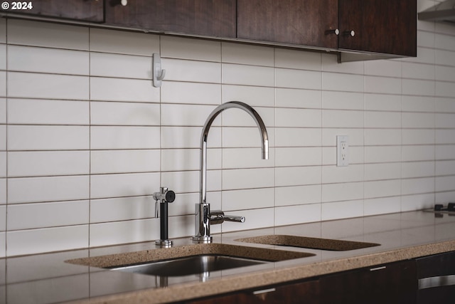 details featuring sink, dark stone countertops, dark brown cabinetry, and decorative backsplash